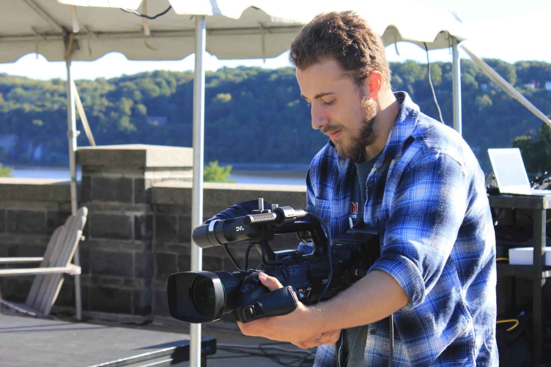 Photo of student with camera