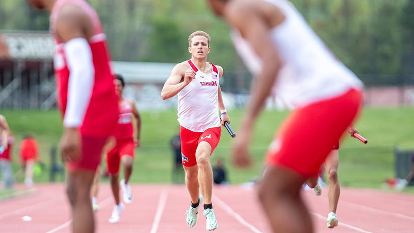 Image of Marist track athletes competing in a relay event.