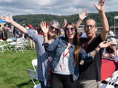 Photo of a student and her parents at Family Weekend